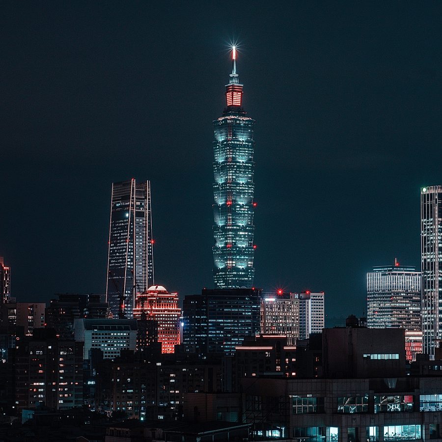 Taipei 101 lit up at night with the surrounding skyline, viewed from the Xiangshan trail